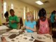 Program participants clipping newspapers for current events project at Windy Hill Community Center