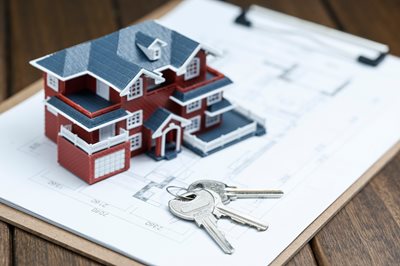 small models home sitting on top of blueprints