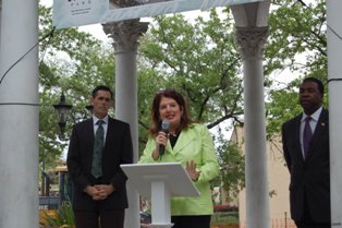 Photo of Councilwoman Lori Boyer addressing the audience from the Balis Gazebo as SMMA Past President Doug Skiles and Mayor Alvin Brown look on.