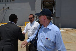 Photo of Mayor Brown greeting Council Member John Crescimbeni as the Councilman disemarks from the USS Iwo Jima.