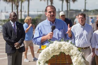 Photo of Council Member John Crescimbeni addressing the crowd during the dedication of the marker honoring the La Caroline colonists.