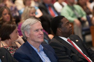 Photo of Congressman Ander Crenshaw, seated next to Mayor Alvin Brown, in the audience at the installation ceremony.