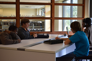 Photo of students utilizing the computer stations in the new Teen Scene space at the San Marco Branch Library.