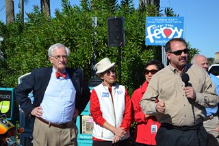 Photo of Council Member John Crescimbeni speaking at the celebration for the retun of the Ferry as Council President Gulliford looks on.