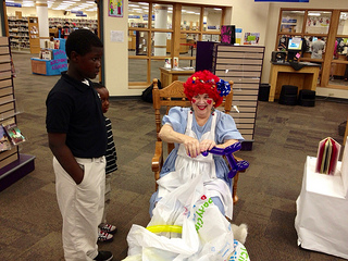 Photo of a clown making ballon animals for children at the Regency Square Branch Library.