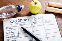 Workout Plan note, bottled water apple on the table