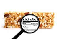 Granola bar with magnifying glass showring nutrition facts