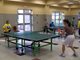 People playing table tennis in the community room at Cecil Community Center