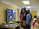 Visitors reading a display inside Dinsmore Community Center