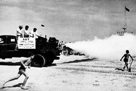 Beach Application of DDT, featuring children running to envelop themselves in the fog