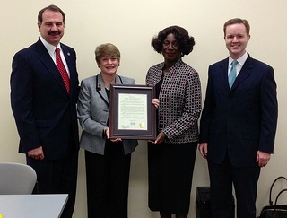 Photo of Council Member John Crescimbeni with Library Director Barbara Gubbin, Library Board Chairwoman Brenda Simmons, and Council Member Clay Yarborough during the presentation of a City Council resolution commemorating the 40th anniverary of the Regency Square Branch Library.