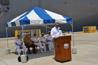 Photo of Council Member John Crescimbeni speaking to the audience at the welcoming ceremony for the USS Iwo Jima and the USS Fort McHenry at Naval Station Mayport.