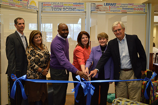 Photo of Council Member Lori Boyer, Library Director Barbara Gubbin. and others cutting the ribbon to open the San Marco Branch Library's new Teen Scene space.