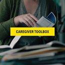 a person holding a handbook and in front of different text book. Caregiver toolbox word highlighted in yellow