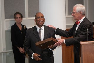 Photo of Council President Bill Gulliford giving Council Member Warren Jones the Mary Singleton Award for his outstanding service as Rules Committee Chair.