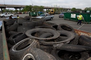 Photo of a waste tires in a disposal roll-off container.